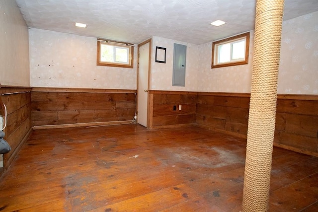 42 Giasson St, Hudson, MA 01749 - below grade area featuring electric panel, wainscoting, healthy amount of natural light, wooden walls, and wood-type flooring