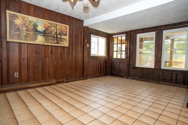 42 Giasson St, Hudson, MA 01749 - unfurnished room featuring wood walls, light tile patterned floors, and ceiling fan