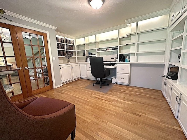 office area featuring ornamental molding, built in study area, a textured ceiling, french doors, and light wood-style flooring