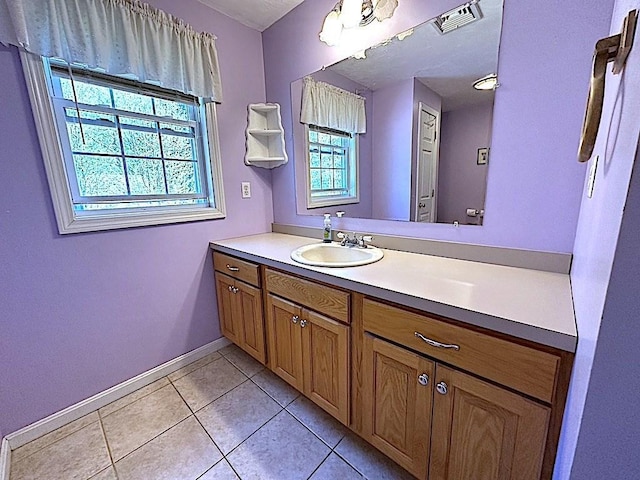 bathroom with visible vents, baseboards, tile patterned flooring, and vanity