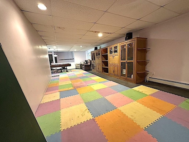 playroom with recessed lighting, tile patterned floors, a baseboard heating unit, and a drop ceiling