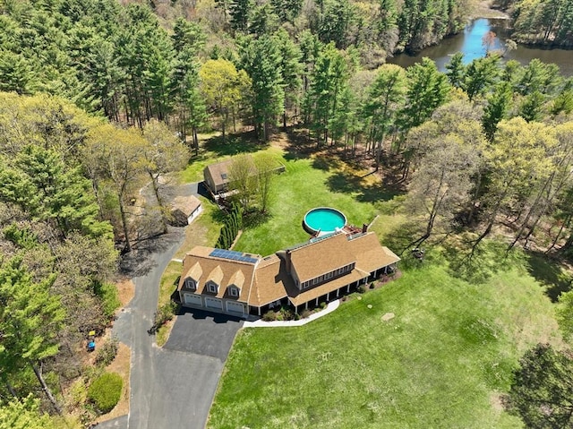 birds eye view of property featuring a water view and a forest view
