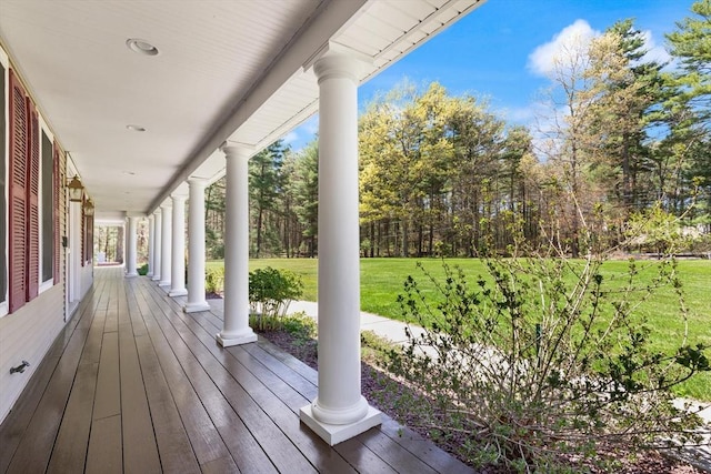 deck with a porch and a yard