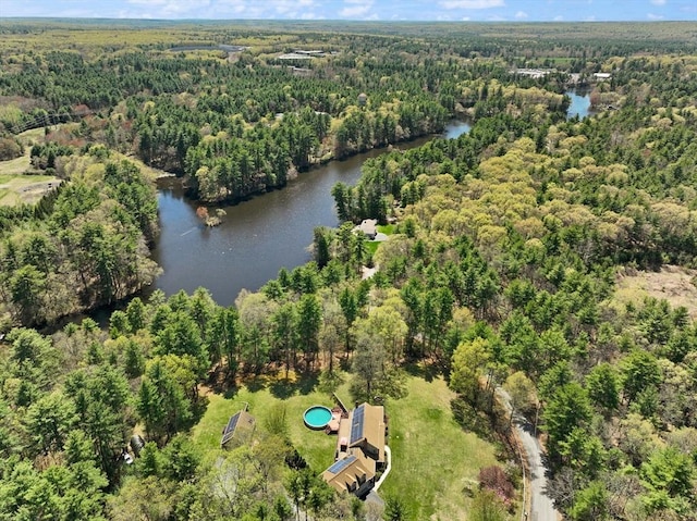 birds eye view of property with a forest view and a water view