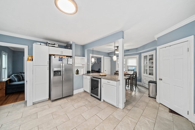 kitchen featuring white cabinets, decorative light fixtures, stainless steel fridge with ice dispenser, and wine cooler