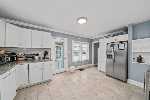 kitchen featuring dark stone counters, stainless steel refrigerator with ice dispenser, white dishwasher, and white cabinets