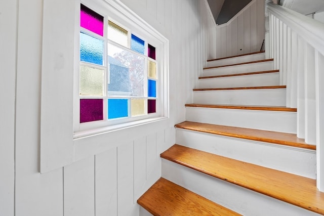 staircase with wooden walls