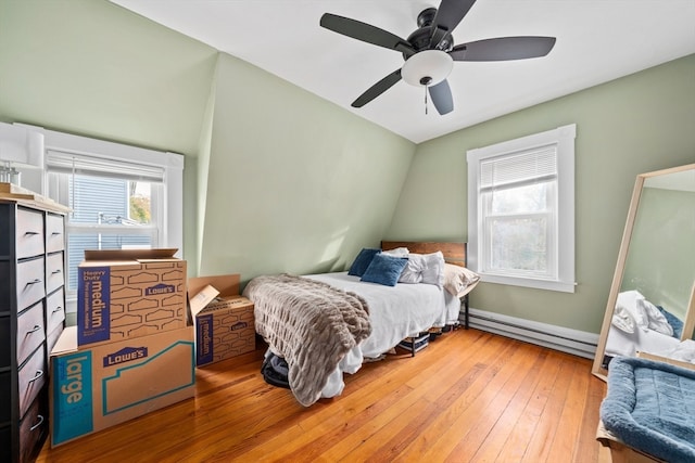 bedroom featuring wood-type flooring, ceiling fan, and a baseboard radiator