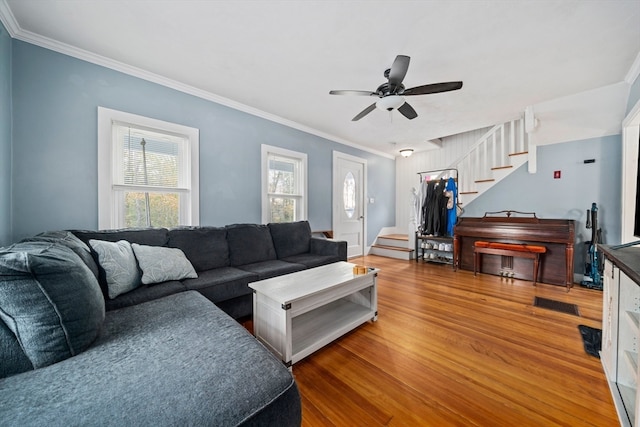 living room featuring ceiling fan, wood-type flooring, and ornamental molding