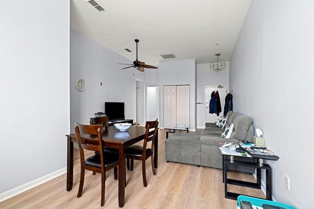 dining space featuring baseboards, visible vents, a ceiling fan, and light wood finished floors