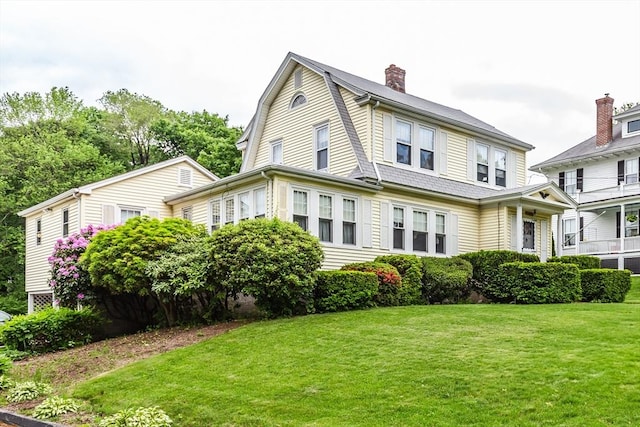 34 Worcester St, Grafton, MA 01519 - view of front of property with a front yard, a gambrel roof, and a chimney