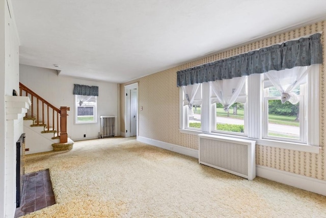 34 Worcester St, Grafton, MA 01519 - unfurnished living room featuring radiator heating unit, carpet, wallpapered walls, and stairway