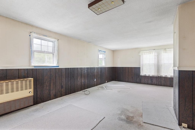 34 Worcester St, Grafton, MA 01519 - spare room featuring wainscoting, wooden walls, carpet floors, a textured ceiling, and heating unit