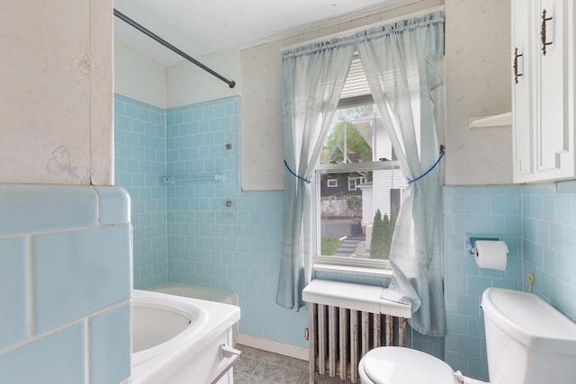 34 Worcester St, Grafton, MA 01519 - bathroom featuring toilet, tile walls, radiator heating unit, and bathtub / shower combination