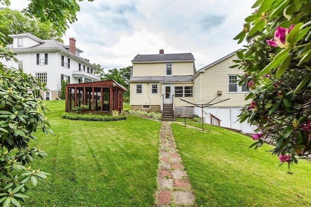 34 Worcester St, Grafton, MA 01519 - rear view of house with a sunroom, a yard, and a chimney