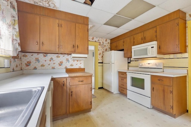 34 Worcester St, Grafton, MA 01519 - kitchen with white appliances, wallpapered walls, light floors, a drop ceiling, and a sink