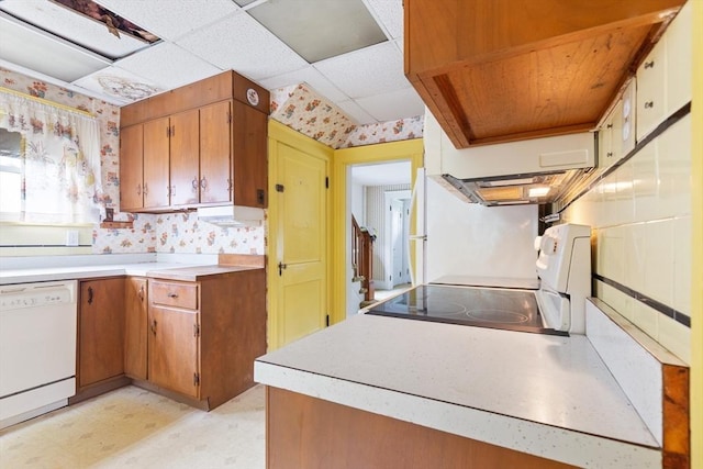 34 Worcester St, Grafton, MA 01519 - kitchen with white appliances, light flooring, wallpapered walls, light countertops, and brown cabinetry
