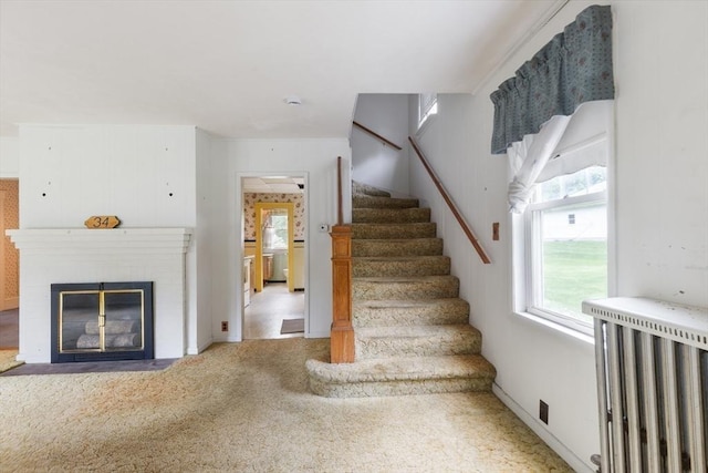 34 Worcester St, Grafton, MA 01519 - stairs featuring radiator heating unit, healthy amount of natural light, carpet flooring, and a fireplace