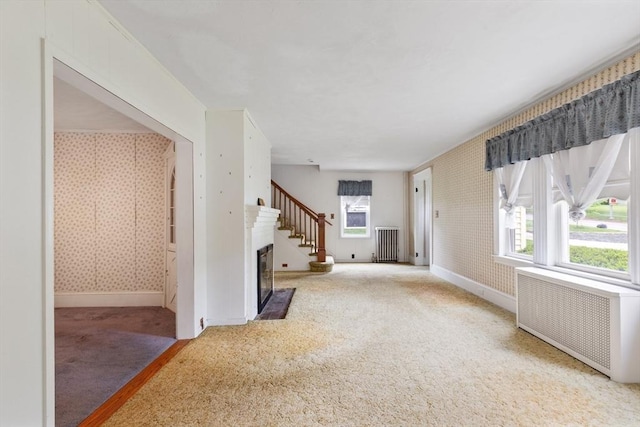 34 Worcester St, Grafton, MA 01519 - unfurnished living room with radiator, carpet floors, radiator heating unit, baseboards, and healthy amount of natural light