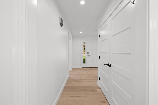 hallway with light hardwood / wood-style flooring