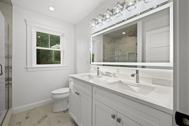 bathroom featuring a shower with door, vanity, and toilet