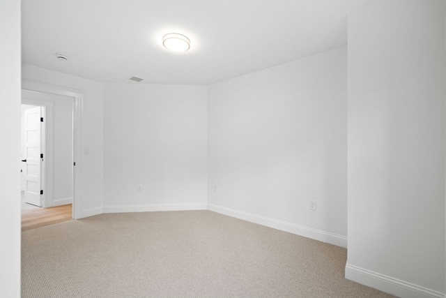 empty room featuring light colored carpet