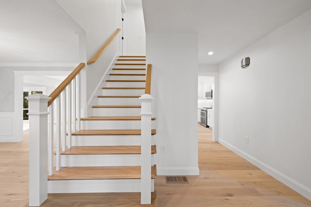 stairs with hardwood / wood-style flooring