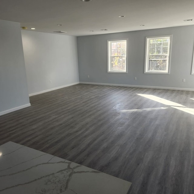 empty room with dark wood-type flooring