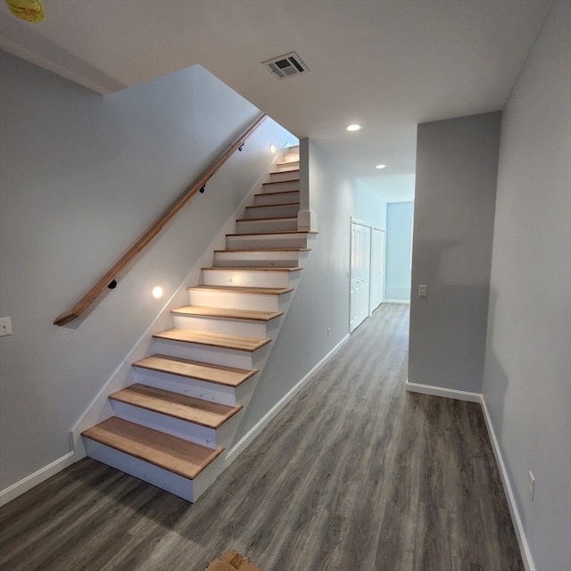 stairs featuring hardwood / wood-style floors