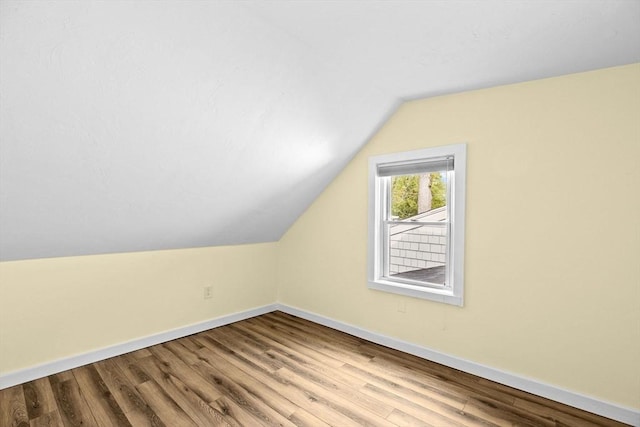 216 Waltham St, Hanson, MA 02341 - additional living space featuring baseboards, vaulted ceiling, and wood finished floors