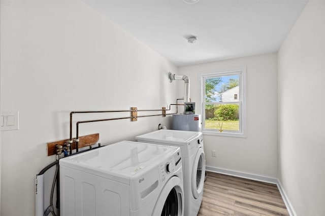 216 Waltham St, Hanson, MA 02341 - laundry area with washer and clothes dryer, water heater, light wood finished floors, and baseboards