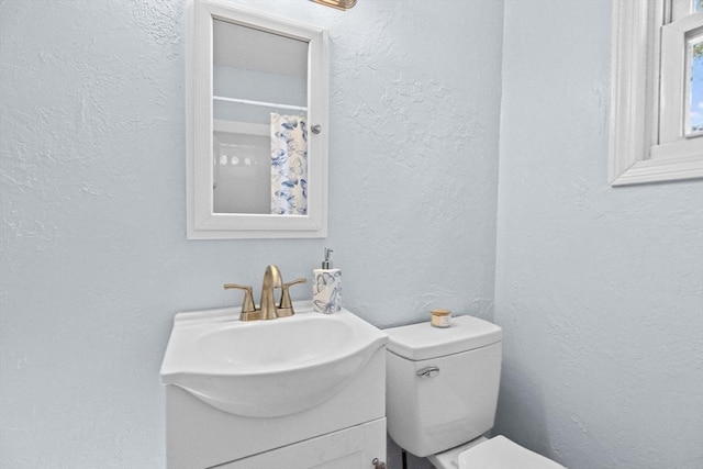 216 Waltham St, Hanson, MA 02341 - bathroom featuring toilet, a textured wall, and vanity