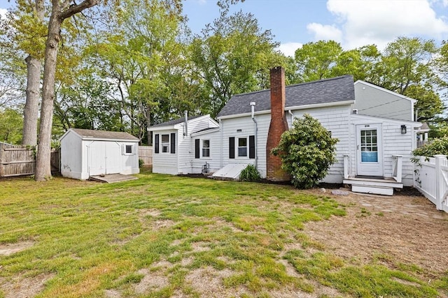 216 Waltham St, Hanson, MA 02341 - rear view of property with a storage unit, a chimney, an outbuilding, a shingled roof, and a wooden deck