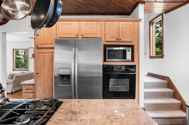 31 Cedar Hill Ter, Swampscott, MA 01907 - kitchen with black appliances, wood ceiling, healthy amount of natural light, light stone counters, and light brown cabinetry