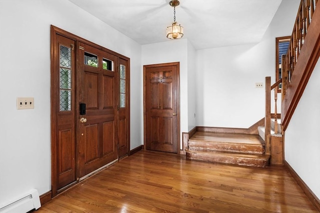 31 Cedar Hill Ter, Swampscott, MA 01907 - entrance foyer featuring baseboard heating, stairs, wood finished floors, and baseboards
