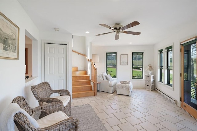 living area featuring a ceiling fan, recessed lighting, a baseboard heating unit, and stairs
