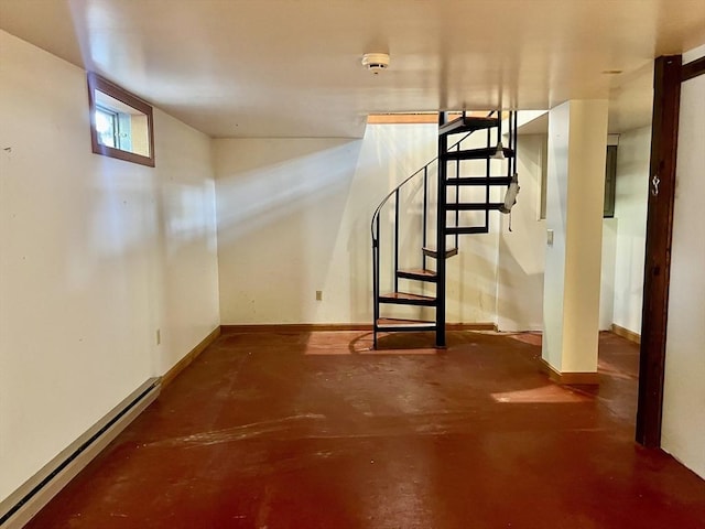below grade area with baseboards, stairway, and baseboard heating