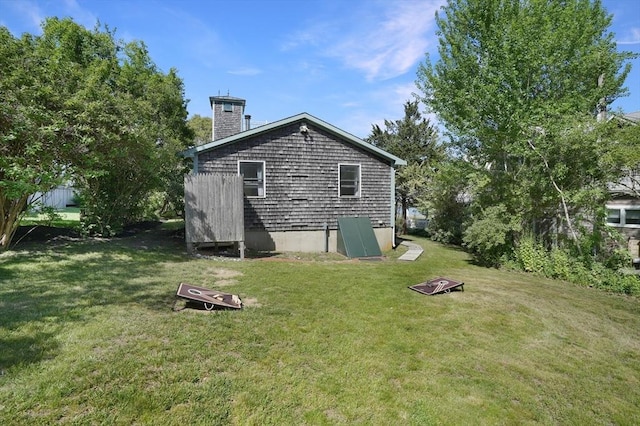 view of property exterior featuring a chimney and a yard