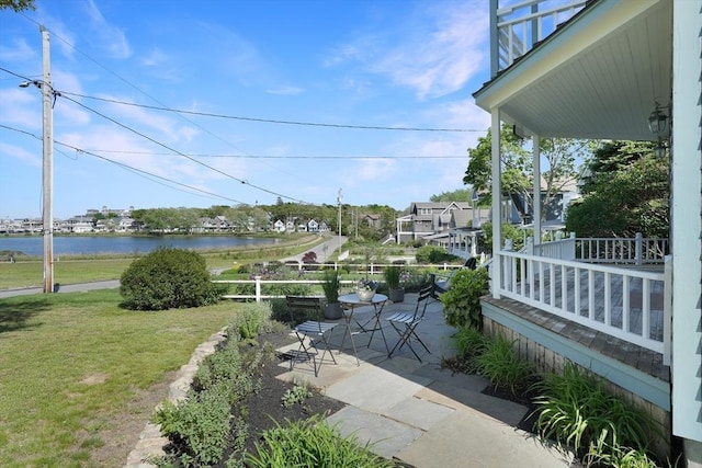 exterior space with a patio and a water view