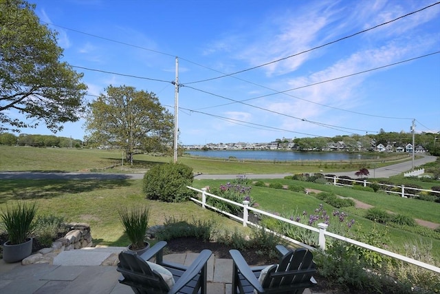 exterior space featuring a water view and fence