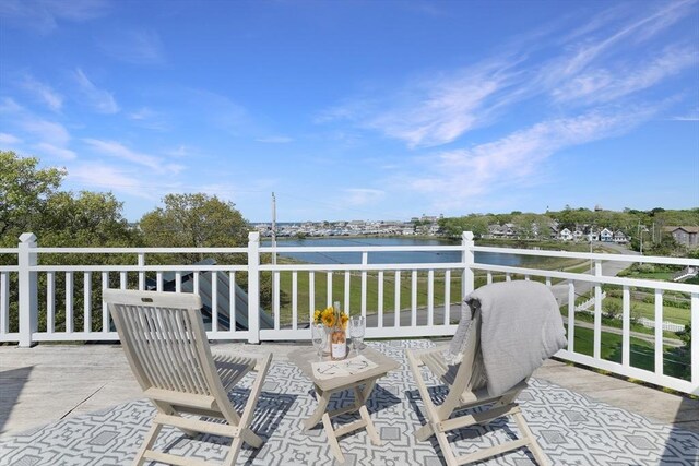 wooden terrace featuring a water view