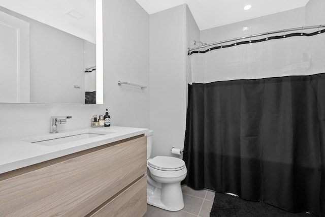 bathroom with tile patterned flooring, a shower with curtain, vanity, and toilet