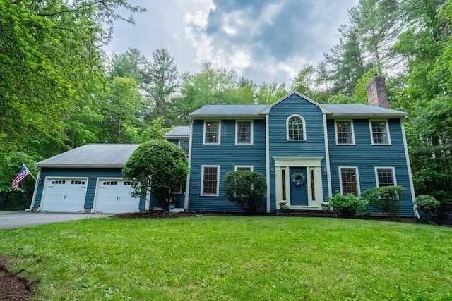 120 Newell Rd, Holden, MA 01520 - colonial home with a chimney, a front lawn, a garage, and view of scattered trees