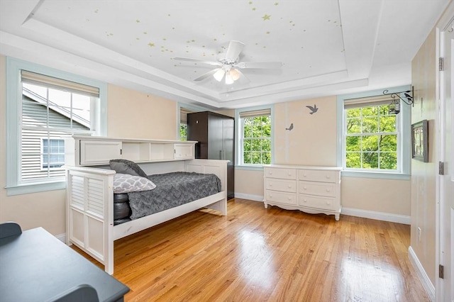 44 Sachem St, Waltham, MA 02451 - bedroom with a tray ceiling, light wood-style flooring, baseboards, and ceiling fan