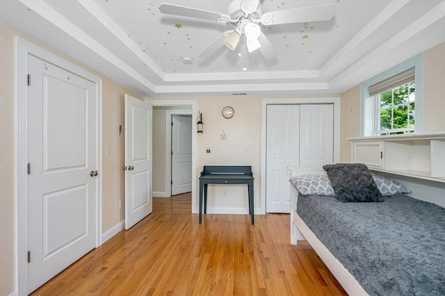 44 Sachem St, Waltham, MA 02451 - bedroom featuring a raised ceiling, light wood-type flooring, a closet, and a ceiling fan