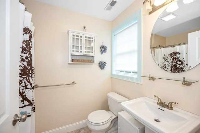 44 Sachem St, Waltham, MA 02451 - bathroom featuring toilet, a sink, and baseboards