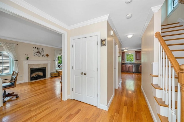 44 Sachem St, Waltham, MA 02451 - hall with light wood-type flooring, stairway, crown molding, and baseboards