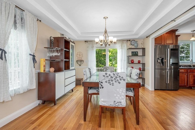 44 Sachem St, Waltham, MA 02451 - dining space featuring a chandelier, light wood-style flooring, baseboards, and a tray ceiling