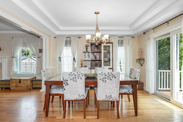 44 Sachem St, Waltham, MA 02451 - dining room featuring a tray ceiling, a chandelier, plenty of natural light, and wood finished floors