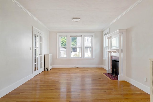 204 Maple St, Boston, MA 02132 - unfurnished living room featuring a fireplace, light wood-type flooring, crown molding, and french doors
